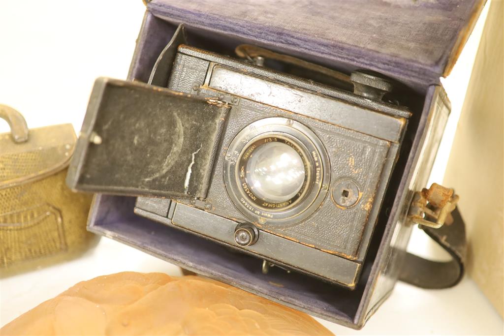 A Taylor & Hobson lense camera, a plaffonier and a tin handbag box